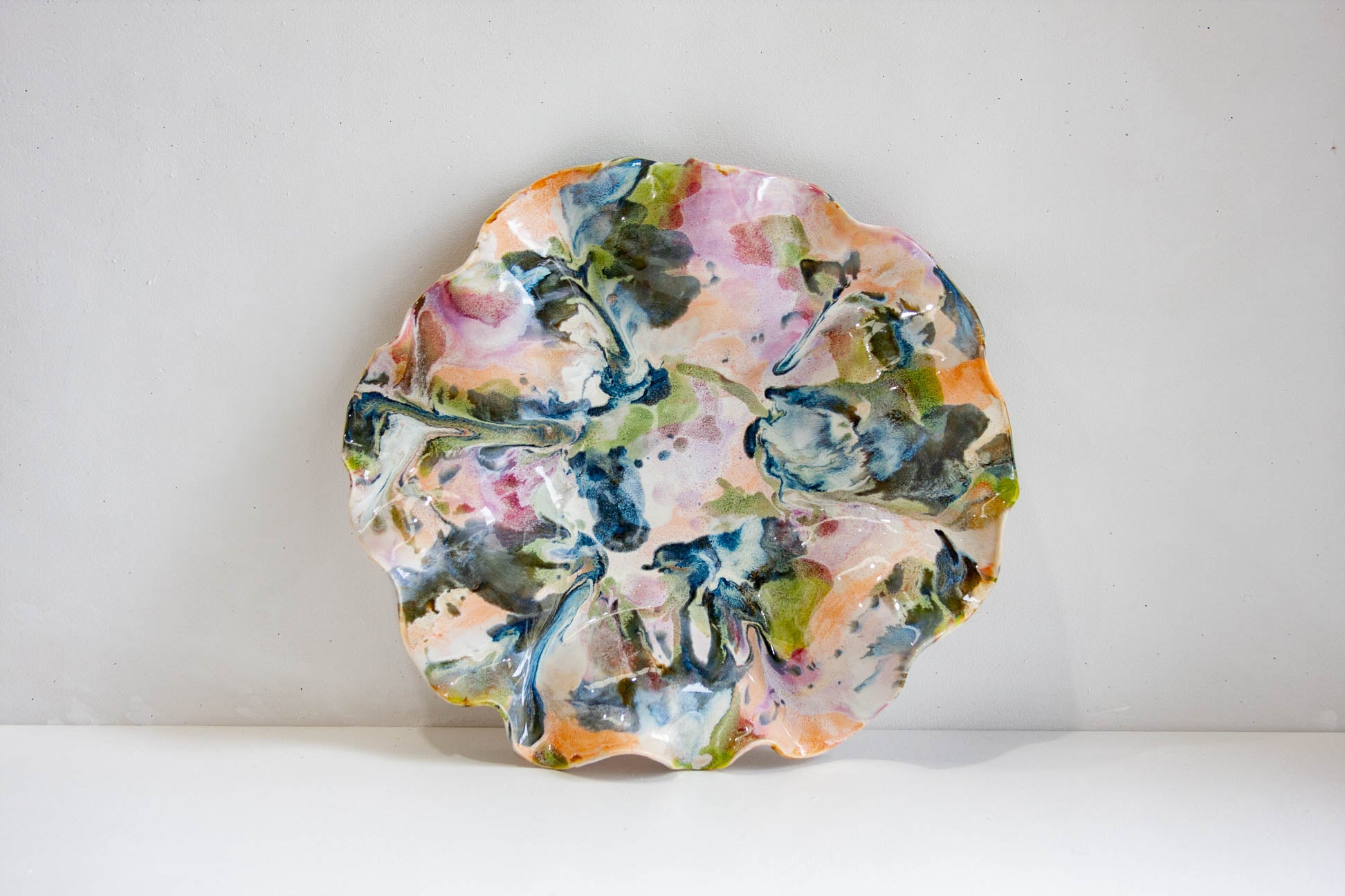 Decorative plate with multicolored abstract design on a white background