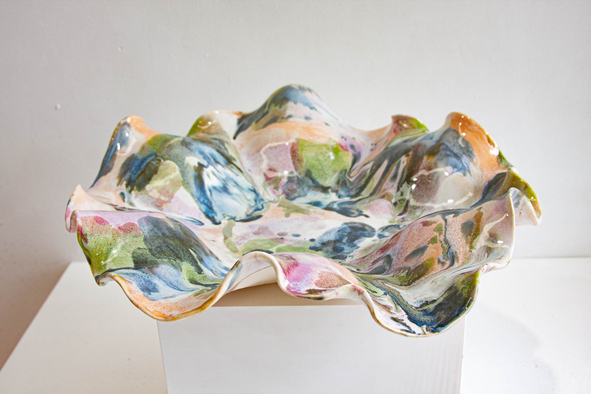 Multicoloured platter bowl on a white surface with a light background
