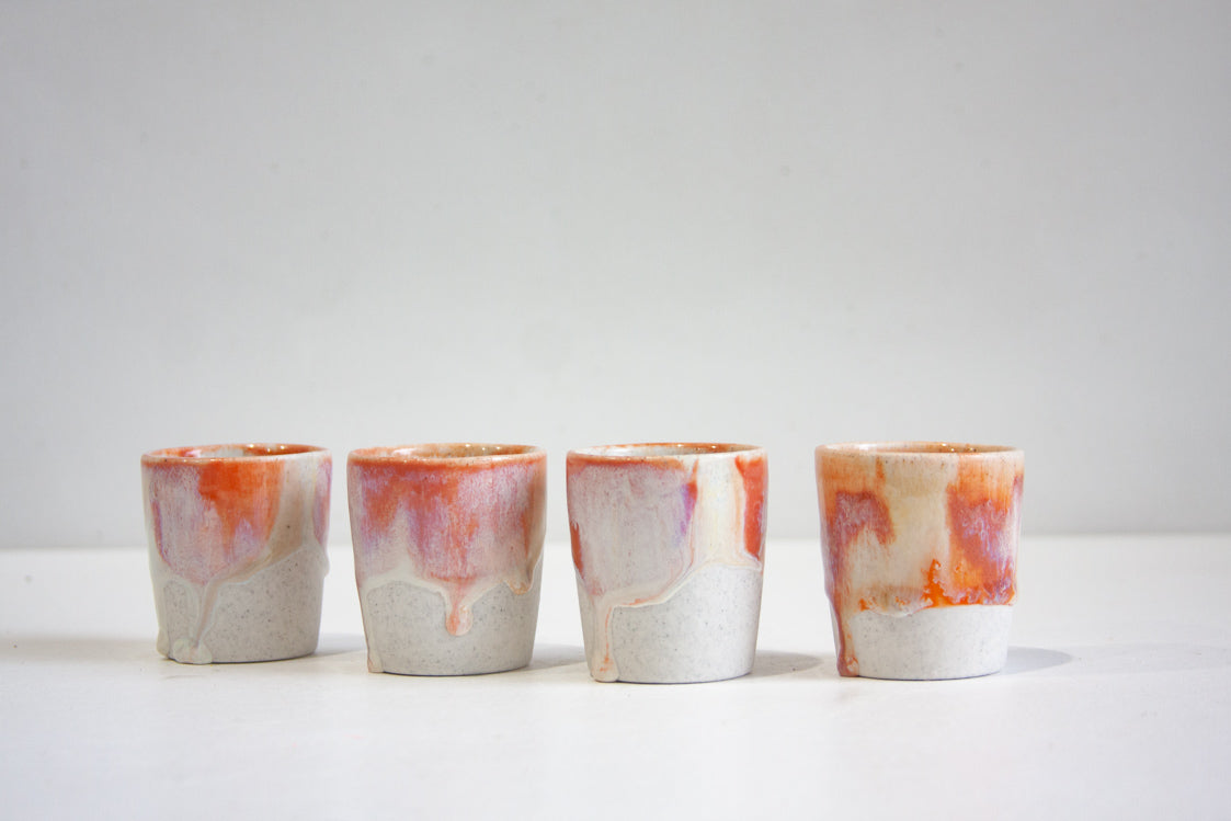 handmade ceramic espresso cup glazed in soft pinks, peach and cream