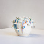 handmade ceramic vase with attached colourful petals