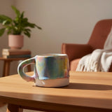 handmade ceramic colourful mug on a coffee table 
