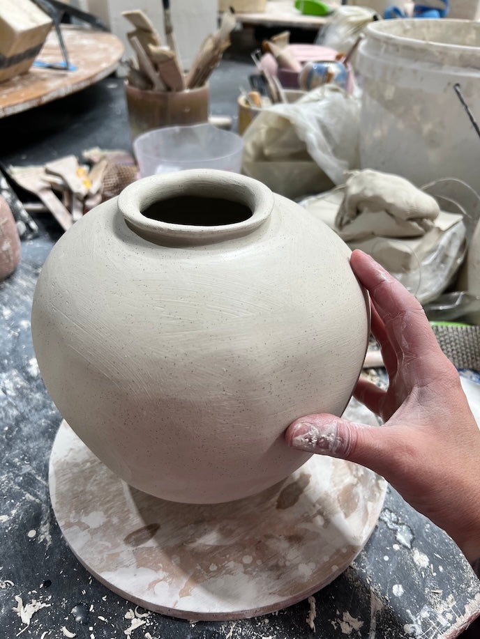 a large sculptural handmade ceramic vase being produced by rhiannon gill at the leather hard stage